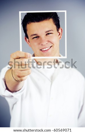 Young man holding up an image of himself