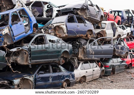 Piled up destroyed cars in the junkyard.