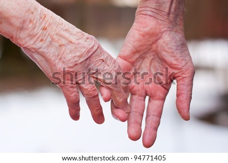 Hands of an elderly couple, close-up.