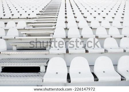 Empty white stadium seats on grandstandof the football stadium.