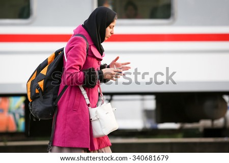 DUGO SELO, CROATIA - SEPTEMBER 17: Syrian refugee woman walking on the railway after arriving from Serbia and waiting for the buses to continue the journey on September 17, 2015 in Dugo Selo,Croatia.