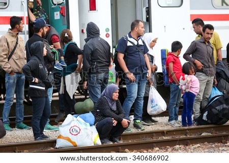 DUGO SELO, CROATIA - SEPTEMBER 17: Syrian refugees on the train tracks after arriving from Serbia and waiting for the buses to continue the journey on September 17th, 2015 in Dugo Selo, Croatia.