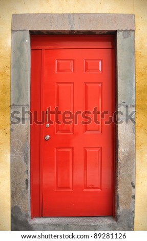 Colorful red door on rough wall