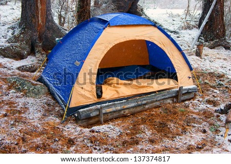 Tourist tent in snow wood in winter