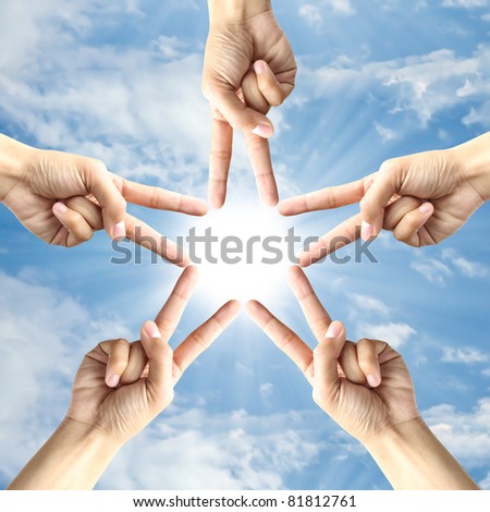 Hand make star sign around the sun