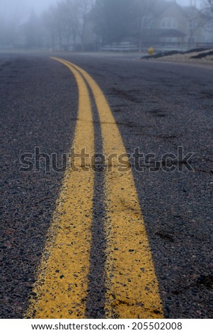 Double yellow lines down an urban roadway