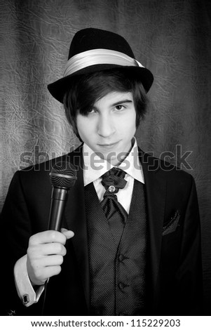 Beautiful teenager holding a black microphone