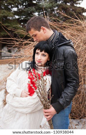 man and woman in the street arm in arm holding a bouquet of seals