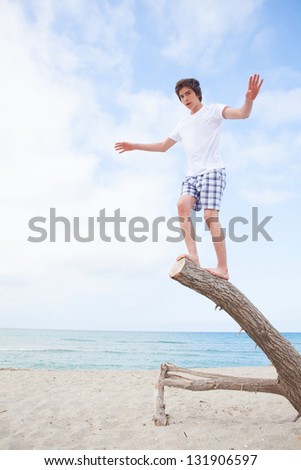 boy on a walk by the sea on a bright sunny day