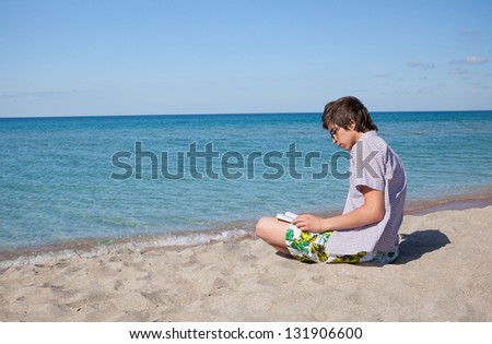 boy on a walk by the sea on a bright sunny day