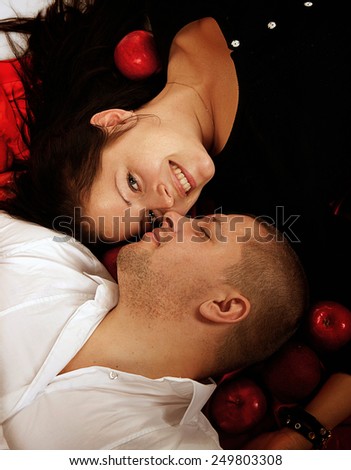 studio portrait of a young couple, man and woman  embrace and kiss, love, Valentine's Day