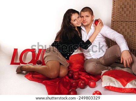 studio portrait of a young couple, man and woman  embrace and kiss, love, Valentine\'s Day