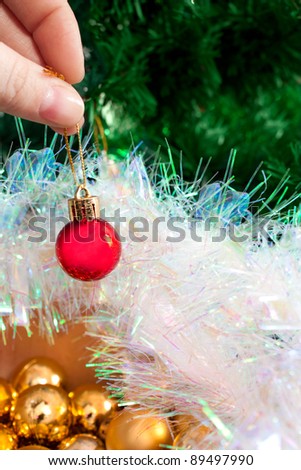 decorate a Christmas tree with colorful round balls