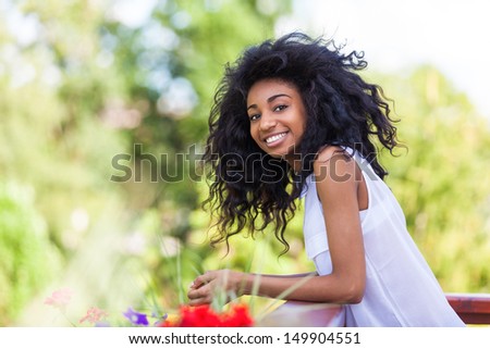 Outdoor portrait of a smiling teenage black girl - African people