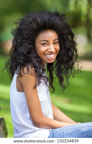 Outdoor portrait of a smiling teenage black girl - African people