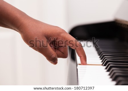 African American hand playing piano  - Touching piano keys - Black people