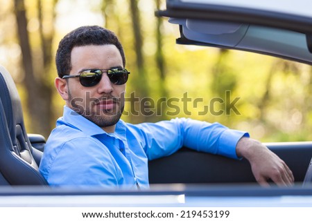 Young black latin american driver  driving his new car