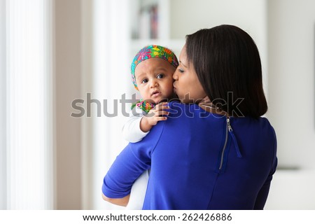 Young african american mother playing with her baby girl