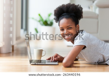 African American woman using a laptop in her living room - Black people