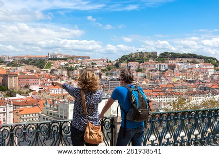 Tourist watching to Lisbon rooftop from Sao Pedro de Alcantara viewpoint - Miradouro in Portugal