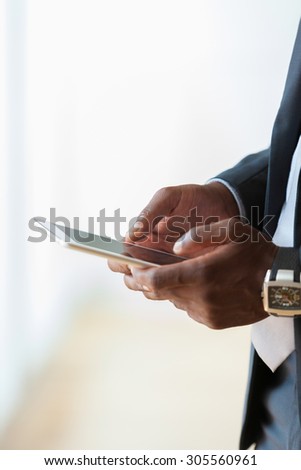 African american business man using a tactile tablet over white background - Black people