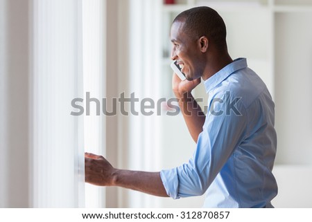 Portrait of a young African American business man using a mobile phone - Black people