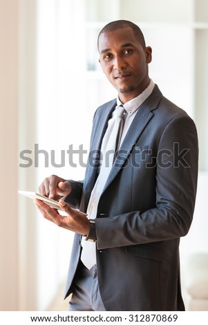 African American business man using a tactile tablet  - Black people