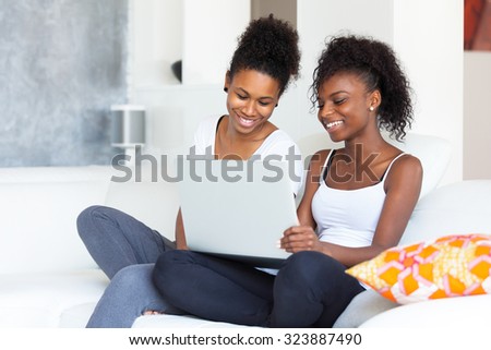 African American student girls using a laptop computer - black people