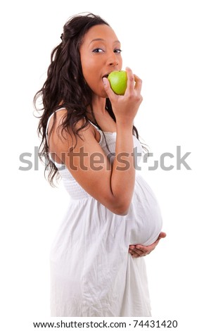 stock photo pregnant black woman eating an apple