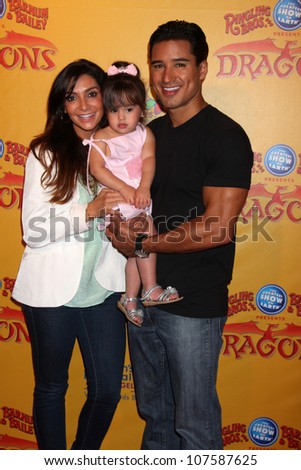 LOS ANGELES - JUL 12:  Courtney Mazza, Mario Lopez and their daughter arrives at \'Dragons\' presented by Ringling Bros. & Barnum & Bailey Circus at Staples Center on July 12, 2012 in Los Angeles, CA