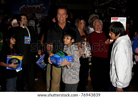 LOS ANGELES - DEC 19: Arnold Schwarzenegger passes out toys at the  Hollenbeck Youth Center\'s 28th \