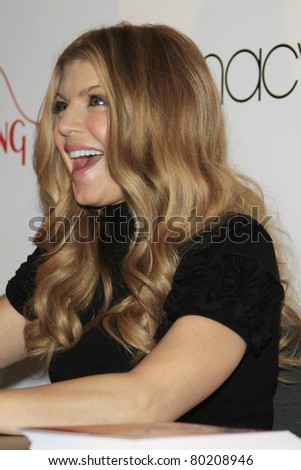 COSTA MESA - DEC 8: Stacy Ferguson aka Fergie launches her handbag collection for Kipling and signs autographs for her fans at Macy's on December 8, 2007  in Costa Mesa, California.