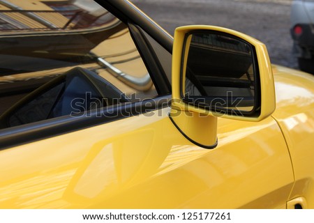 rear view mirror of yellow car