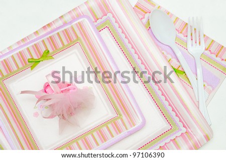 pink and white disposable tableware for baby shower