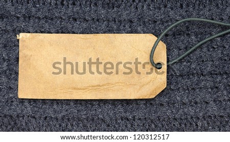 paper price tag with cord over blue linen