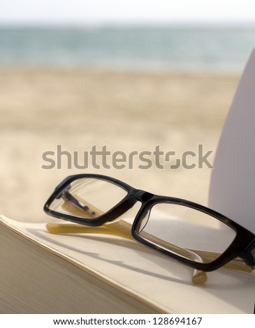 glasses book and ocean
