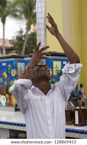 jamaican young man holding empty glasses on his nose
