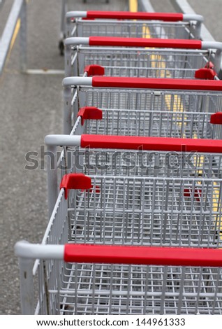 closeup of grocery carts in a parking