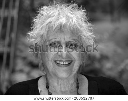 black and white portrait of an happy old woman