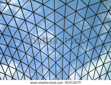 giant glass ceiling with blue sky behind