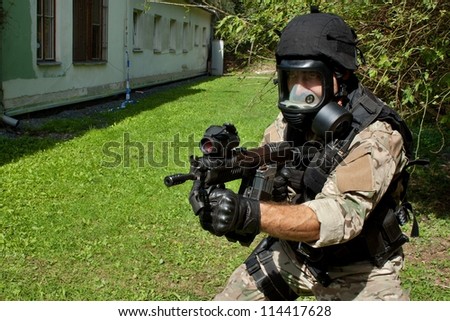 soldier special counterterrorism unit, sa.vz.58 with an assault rifle, caliber 7.62 mm, in a gas mask