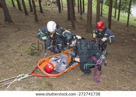 Pnovany, Czech Republic, June 4, 2014: Training rescue of injured people in difficult terrain at the dam Hracholusky, carrying a stretcher with an injured person