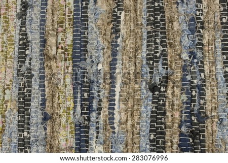 Old cloth carpet texture of. dirty rag, horizontal and vertical stripes, mixed colors