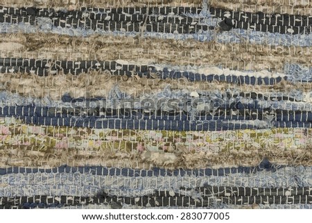 Old cloth carpet texture of. dirty rag, horizontal and vertical stripes, mixed colors