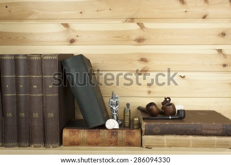 Front view of old books stacked on a shelf. Books without title and author.