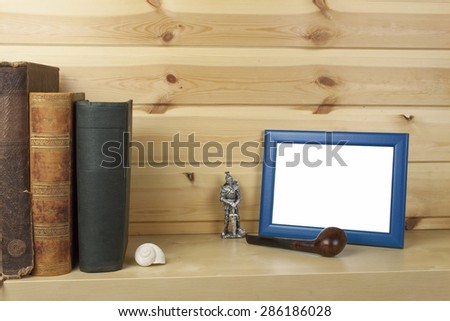 wooden shelf with old books and picture frame for your text.