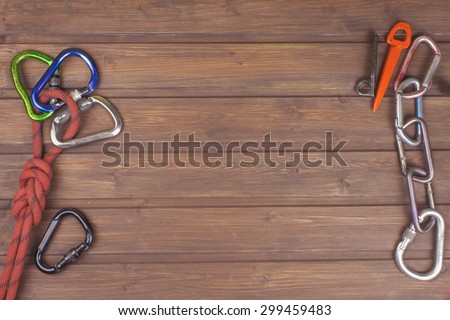 Used climbing gear on wooden background. Advertising boards of trade. The concept of extreme sports. Decoration of older equipment climbers.