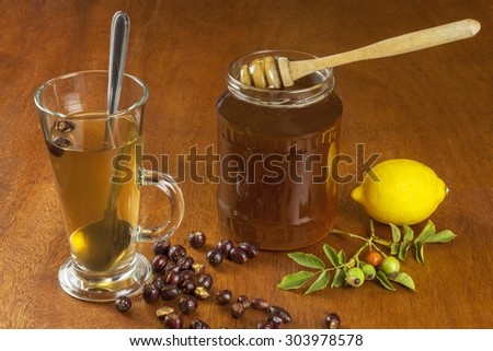 Hot tea with lemon and red arrow in the table. Home treatment for colds and flu. Treating colds using traditional recipes.