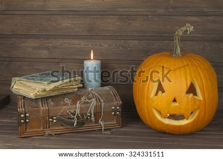 Finding a mysterious wooden box. Mystery enclosed in the cabinet. Retro look of ancient box like pirate treasure chest. Invitation for halloween. Scary Halloween pumpkin. The book of arcane magic
