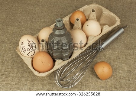 Hand grenade - an egg. Grenade between eggs. Explosive eggs, funny picture. Homemade chicken eggs. Traditional food with protein. Eggs on the table, food preparation. Preparing egg omelet.